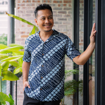 a man in a lifestyle photo in a navy buluh cuban batik shirt