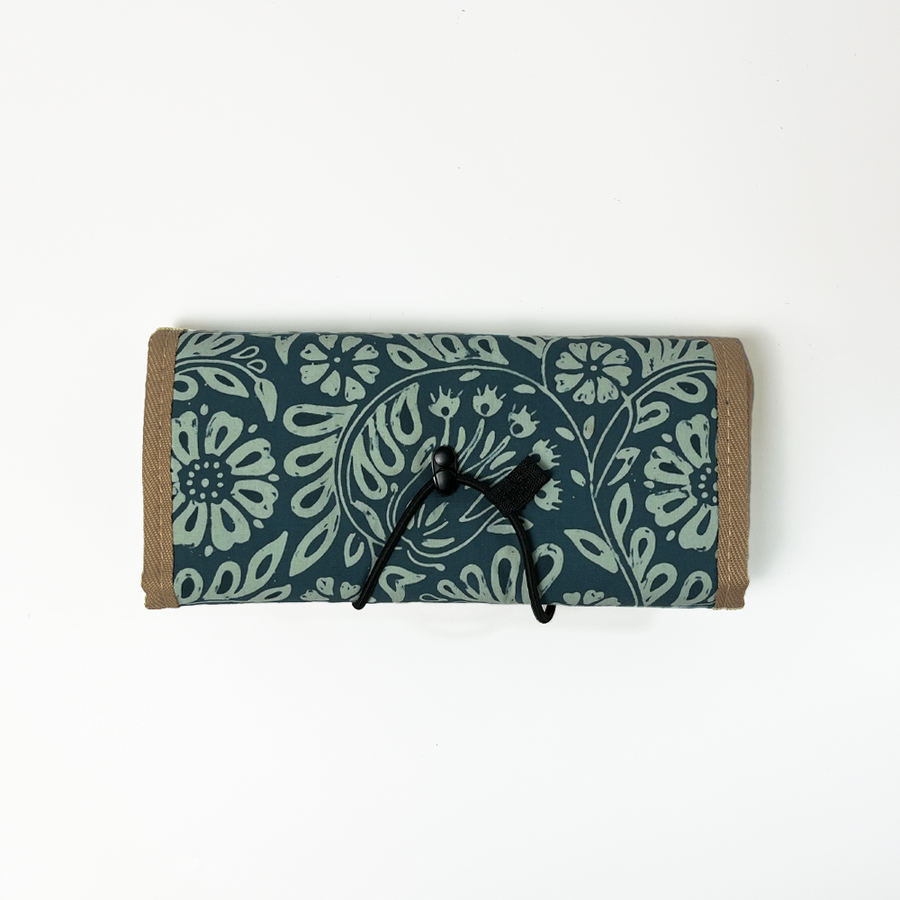 Batik Roll Up Travel Pouch against a white background in the pattern teal ukir