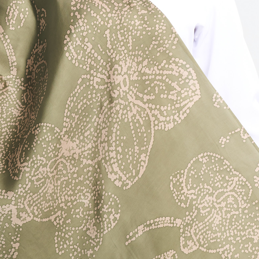 Close-up of the moss green batik scarf with hand-painted orchid motifs