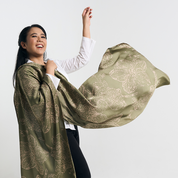 Model joyfully holding and flowing the batik scarf in the air