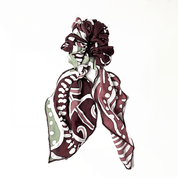 Patterned headband with maroon and white design on a white background