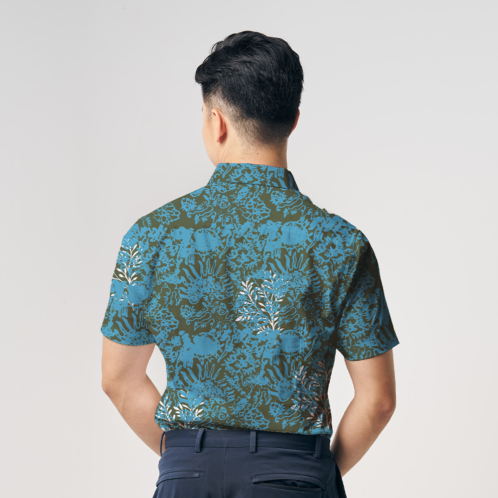 a man facing away from the camera to showcase the details on the back of a batik shirt