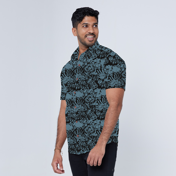 a male model posing in a batik shirt in front of a white background  while wearing a batik shirt in the pattern jet rumpai