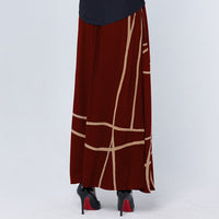 a photo of model wearing crimson color batik skirt in crimson brush pattern