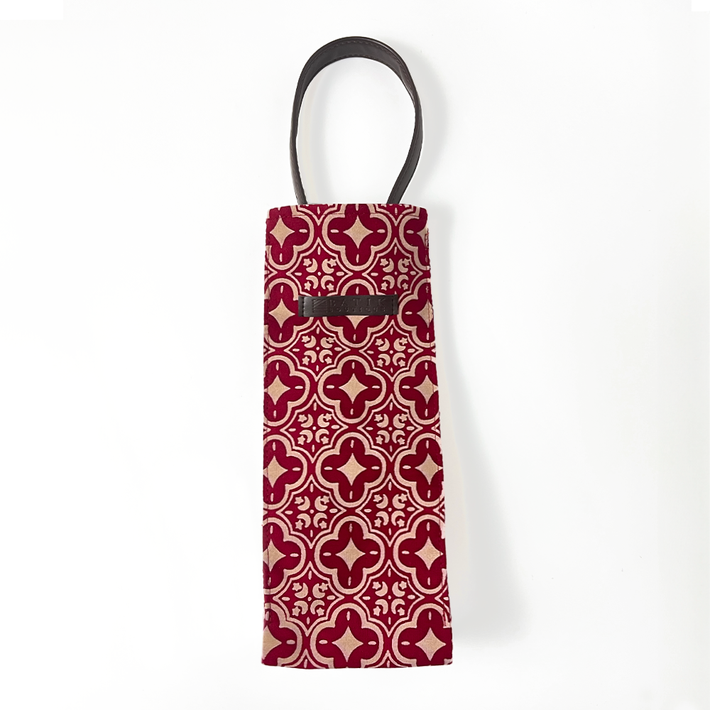 An elegant picture showcasing a wine bag in the Crimson Celestial pattern, crafted from authentic Malaysian batik, against a neutral background
