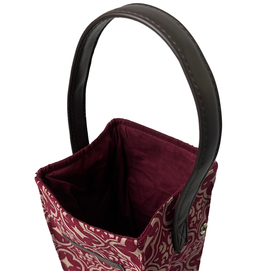 A close-up photo revealing the luxurious interior of a wine bag crafted from authentic batik in the Crimson Celestial pattern, set against a neutral background