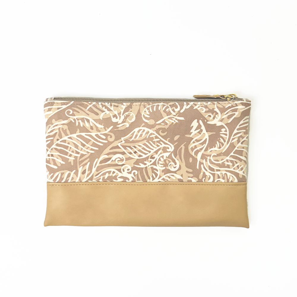 the back side of a tan nautical fern batik zip pouch against a white background