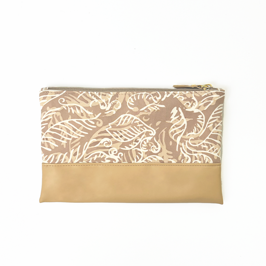 the back side of a tan nautical fern batik zip pouch against a white background