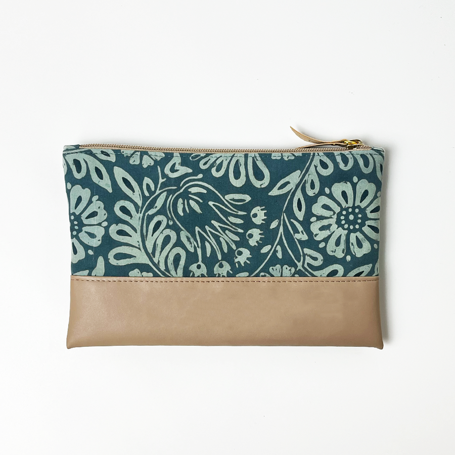 a batik zip pouch in the pattern teal ukir against a white background showing details on the back