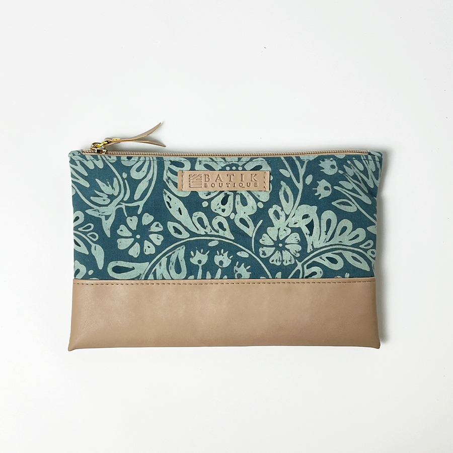 a batik zip pouch in the pattern teal ukir against a white background