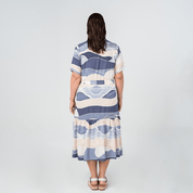 Back view of Batik Boutique’s Button-Up Dress in Lavender Bukit print, featuring a relaxed fit and tiered skirt.
