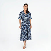Woman wearing a blue floral dress on a white background