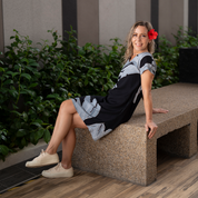 a woman in a lifestyle photo in a batik dress in the pattern midnight palmera