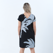 a back view of batik dress against a white background in the pattern midnight palmera