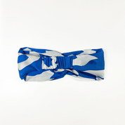 Blue and white patterned headband on a white background