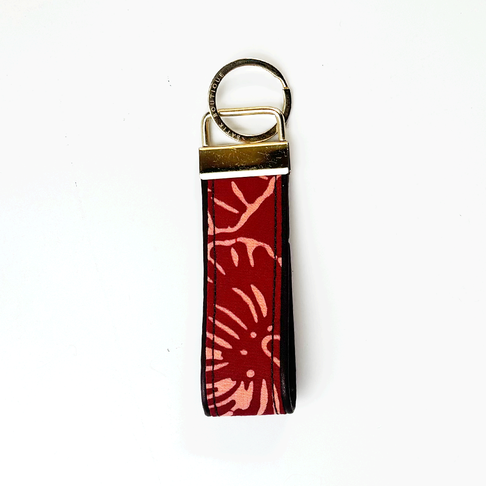 Keychain with red floral pattern on a white background