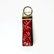 Keychain with red floral pattern on a white background