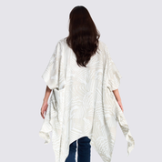Woman facing the back wearing the grey printed batik kimono, to show the design and details of the back