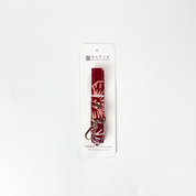 Red and white patterned dog collar on a white background with 'Batik Boutique' branding.
