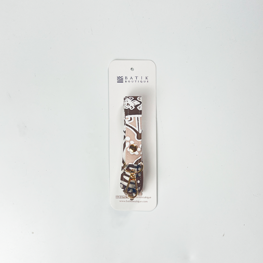 Camouflage-patterned keychain on a white card with 'Batik Boutique' branding, on a light gray background