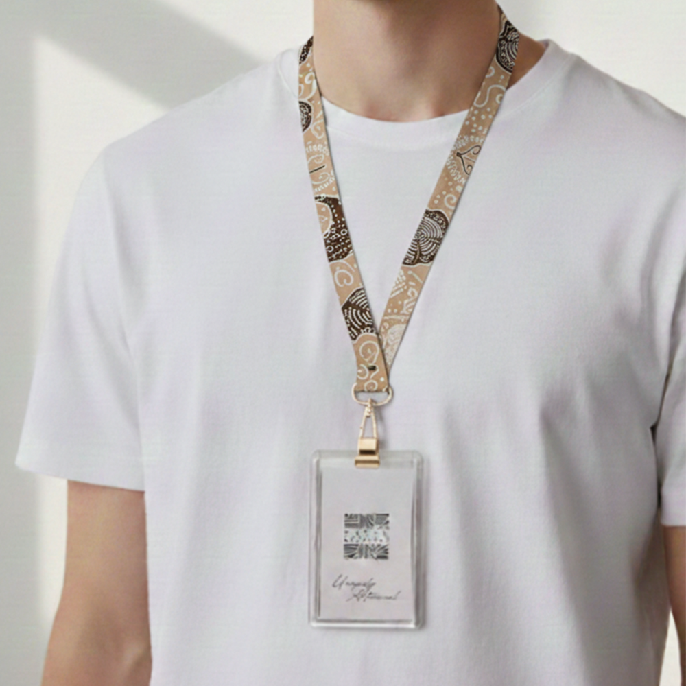 Person wearing a white shirt with a patterned lanyard and badge holder.