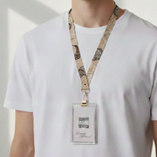 Person wearing a white shirt with a patterned lanyard and badge holder.
