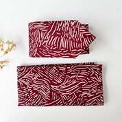 Folded up Crimson driftwood tie and crimson driftwood pocket square 