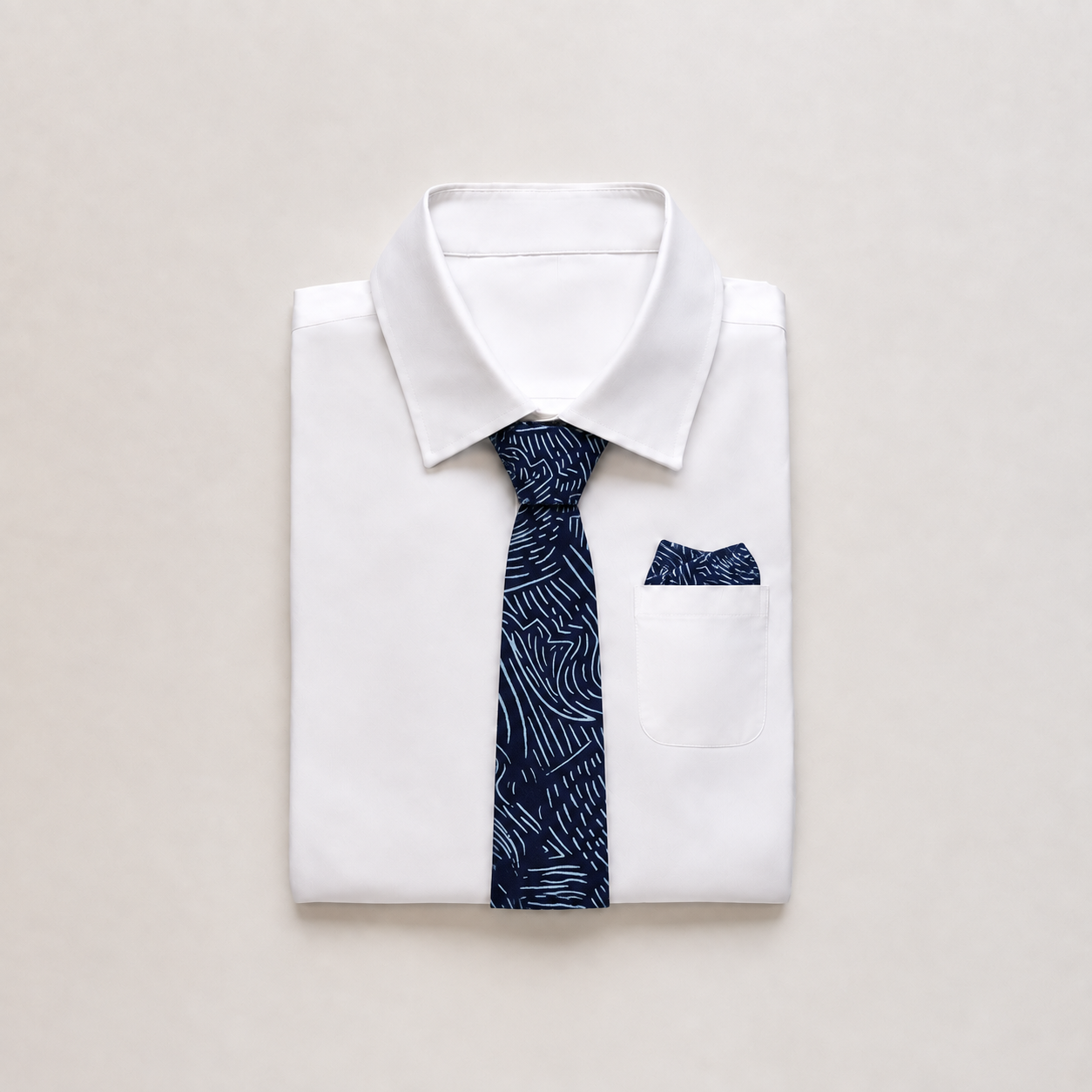 Batik blue printed neck tie and pocket square in a folded suit
