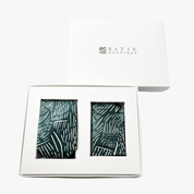 A gift set containing two batik neckties with a dark green and white leaf pattern, presented in a white box with the brand 'BATIK BOUTIQUE' printed on the lid.