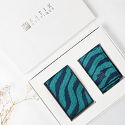 green and blue neck tie and pocket square in a box
