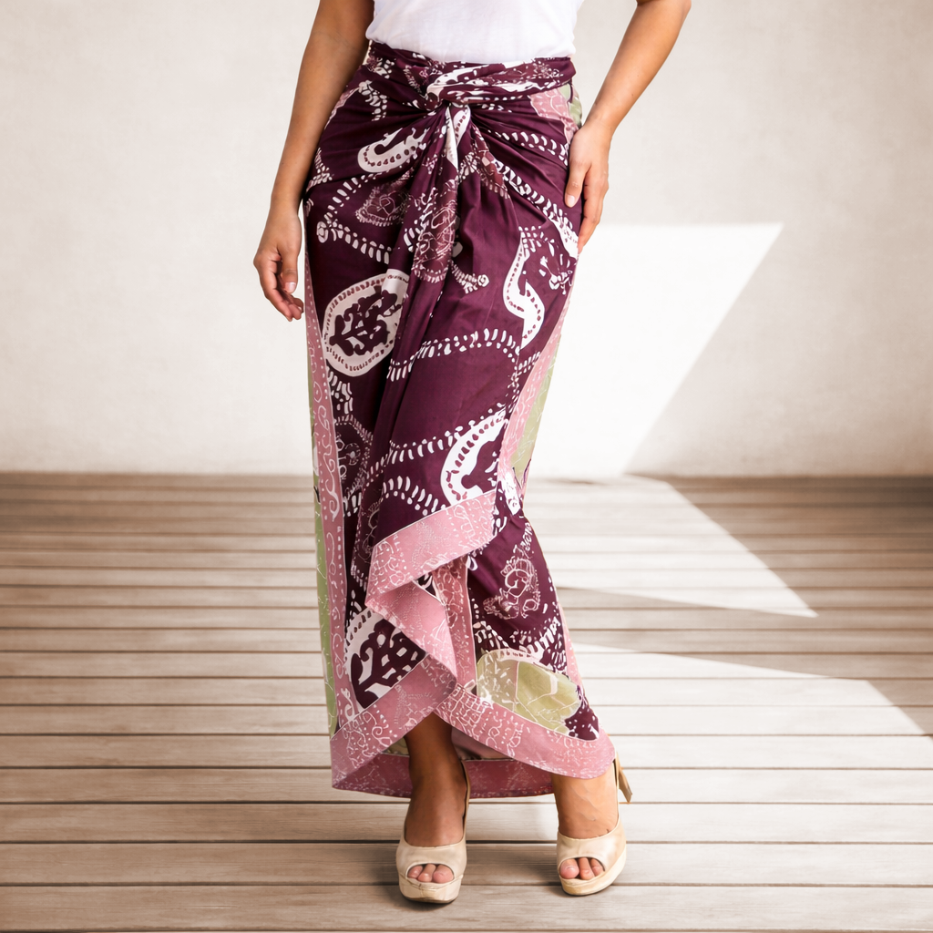 Person wearing a patterned purple skirt on a wooden floor.