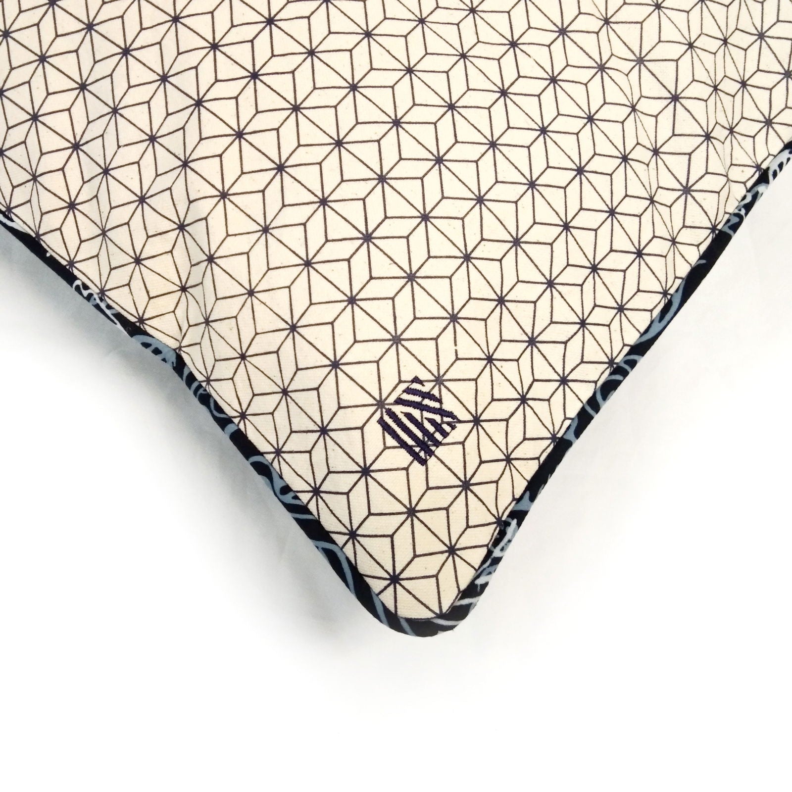 a batik cover with embroidered logo on a batik cover