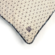 a batik cover with embroidered logo on a batik cover