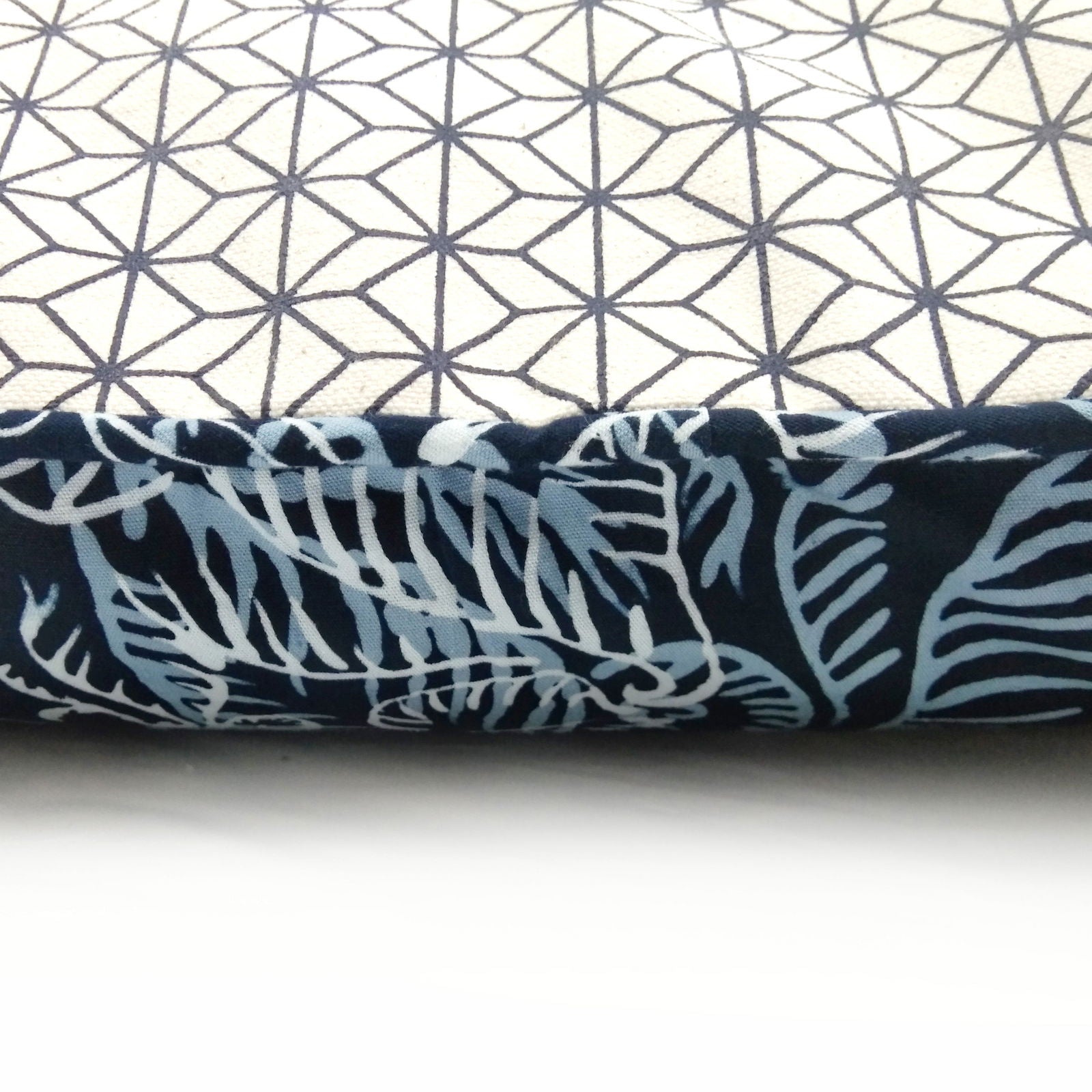 a closeup of batik pillow cover in the pattern blue nautical fern