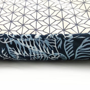 a closeup of batik pillow cover in the pattern blue nautical fern