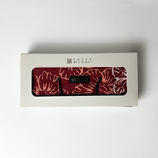 Batik Boutique product packaging with a red floral pattern on a white background