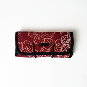 Floral-patterned bag with a visible brand logo on a white background