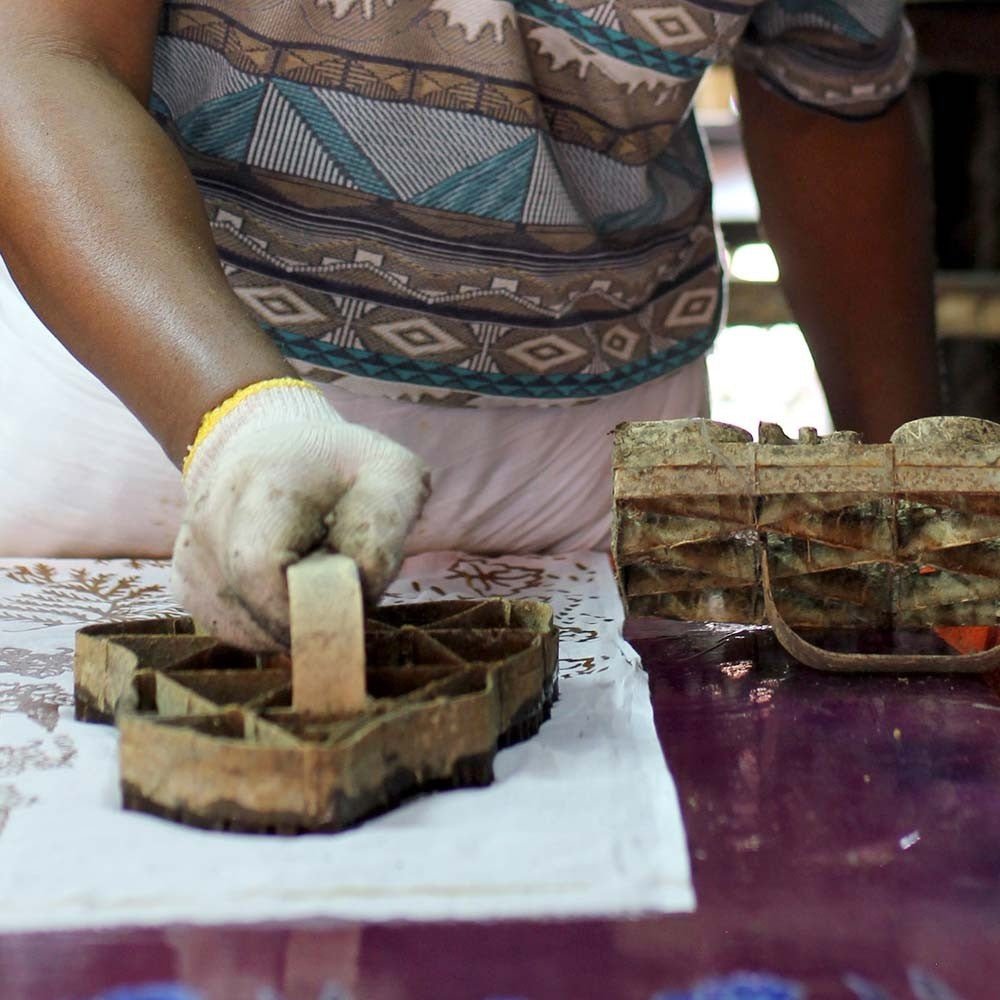 Person working with wooden molds on a table