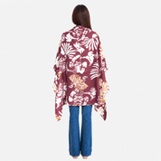 Woman wearing maroon printed batik scarf facing the back