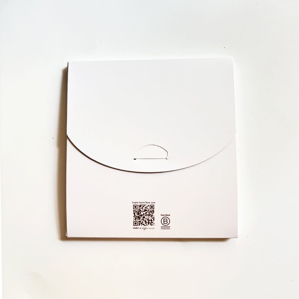 White box with a QR code and logo on a white background