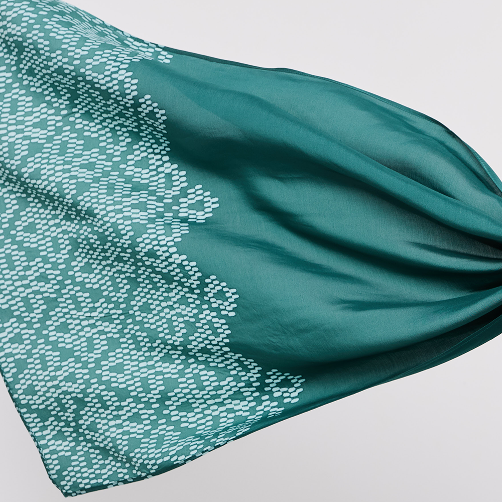 Teal fabric with a subtle pattern on a light gray background