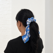 Woman wearing light blue printed scrunchy