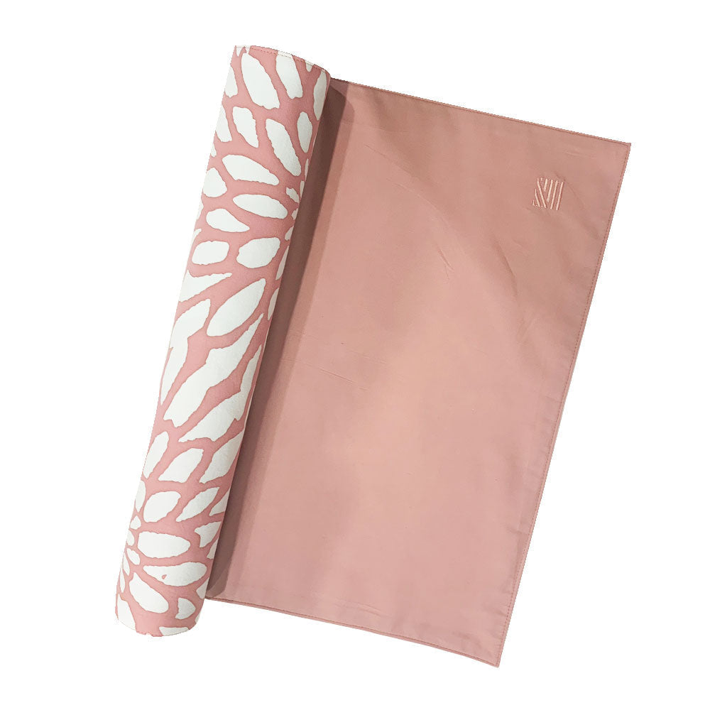a batik table runner against a white background in the pattern coral bunga