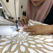 seamstress in the process of sewing batik