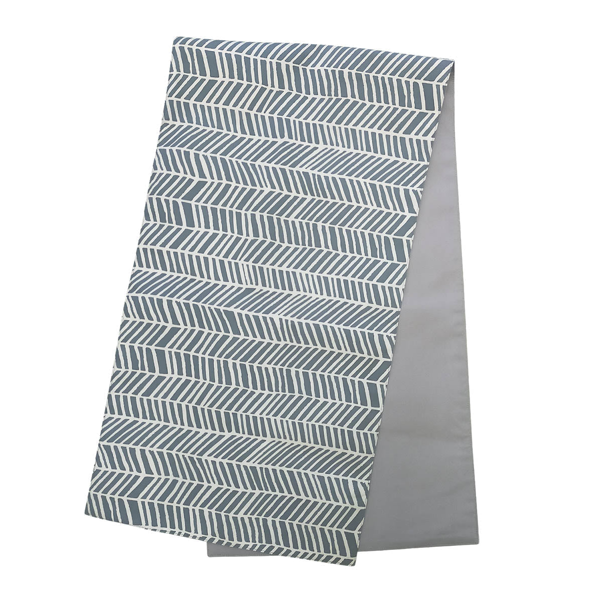 a batik table runner against a white background in the pattern grey banana leaf