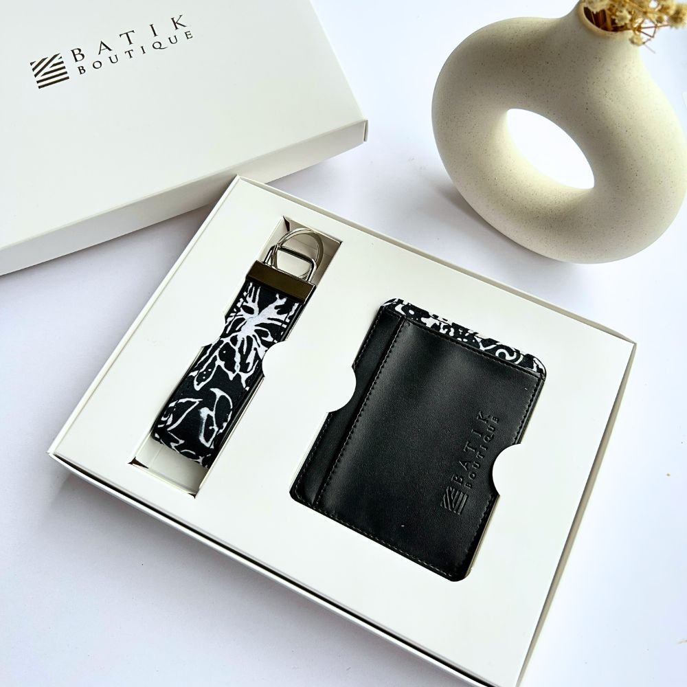 Black leather wallet and keychain set in a box with 'Batik Boutique' branding, on a white background.