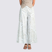 Woman wearing grey printed batik wide leg trousers facing the front, showing front details