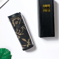 a lifestyle photo of a black diwanie tumbler made of batik against a neutral background