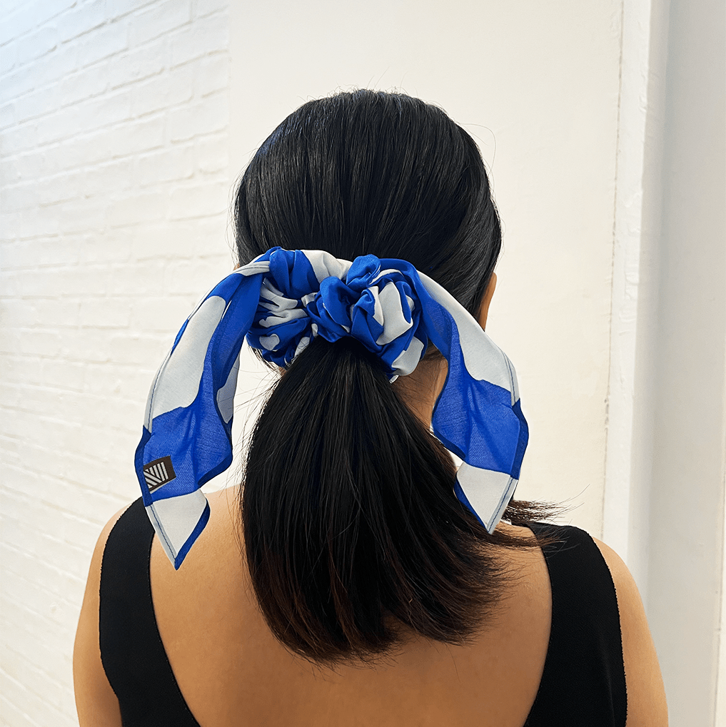 Woman wearing Blue Rimba batik scrunchie with ribbon tail.