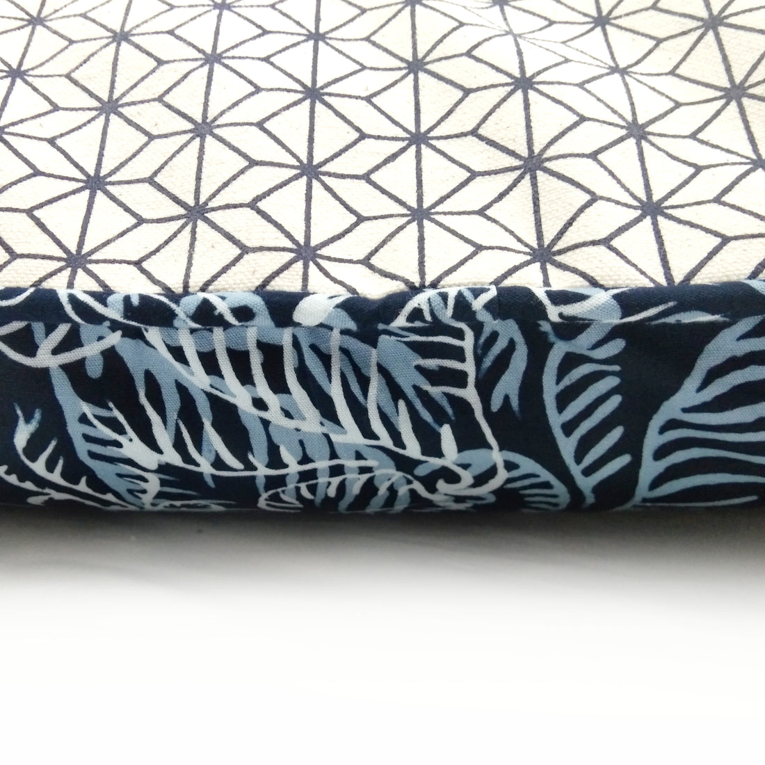 A close up photo of batik pillow cover in blue nautical fern pattern showing detail of the pattern